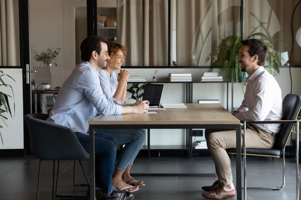 3 professionals working around the table